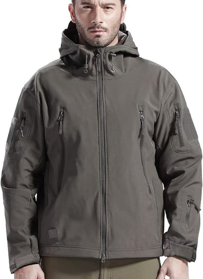 Man wearing the grey hooded jacket, front view, with toggle drawcords at the hood and several zipped pockets. 8